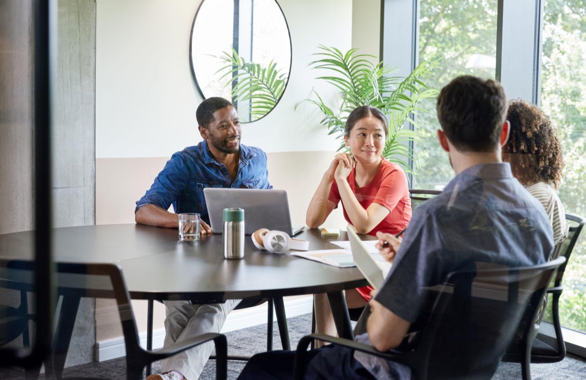 A team in discussion around a meeting table